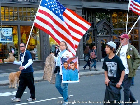 Boston Veterans Day Parade marchers carrying reminders of the costs of war  