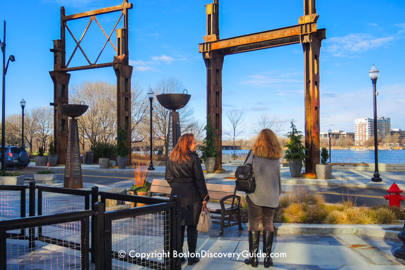 Gate-like sculptures along the edge of Assembly Row's riverside park