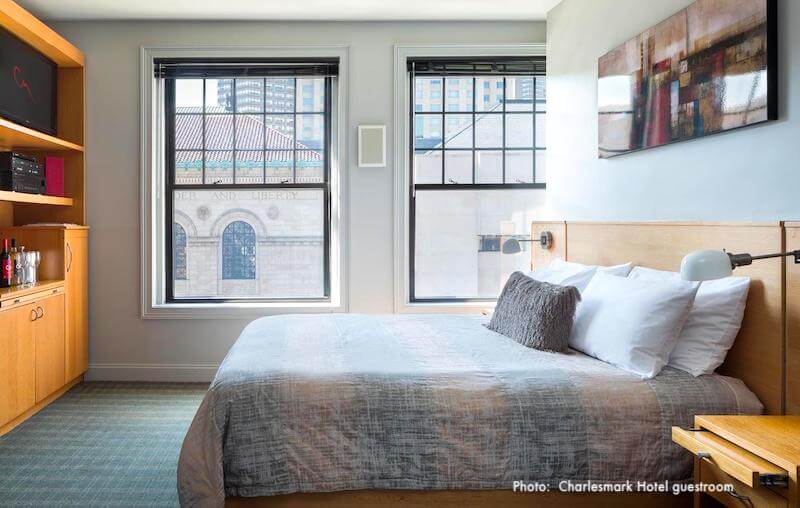 Guestroom in Charlesmark Hotel, with window views of the Boston Public Library 