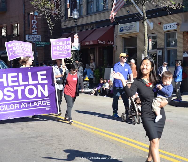 Boston City Counciler At-Large Michelle Wu marching down Hanover Street in the Columbus Day Parade Boston City Counciler At-Large Michelle Wu marching down Hanover Street in the Columbus Day Parade