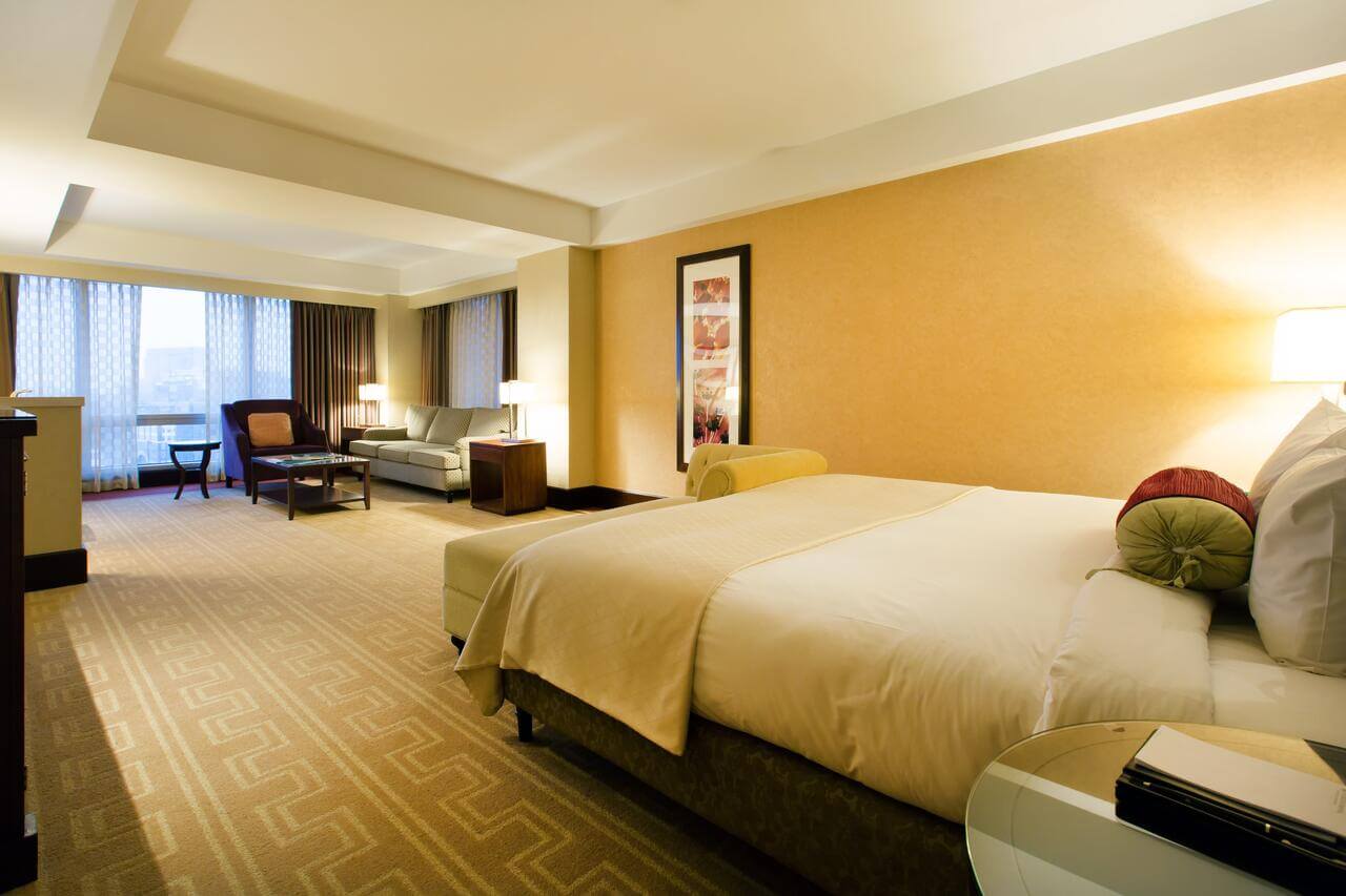 Guestroom with sitting area overlooking Boston Harbor at the InterContinental
