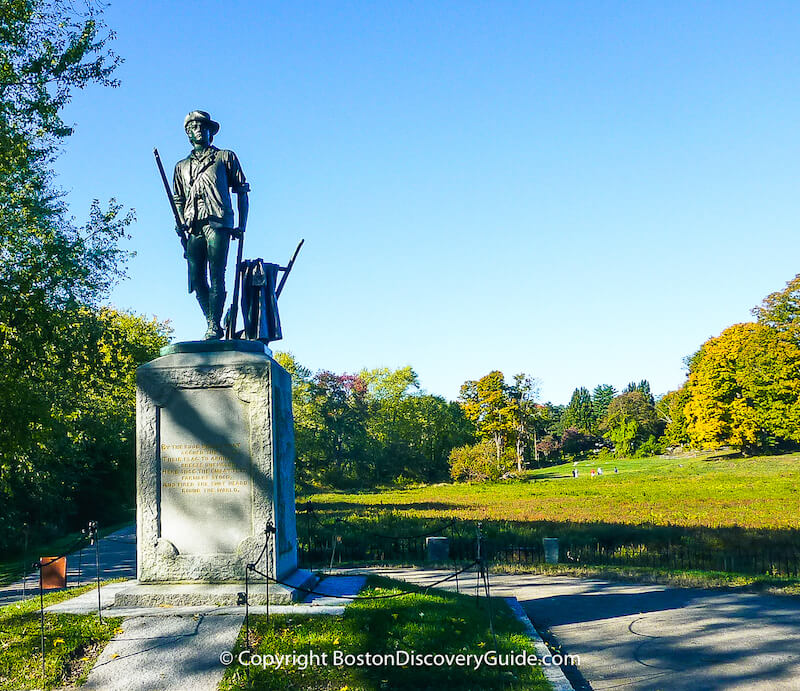 Colonial reenactor crossing Old North Bridge in Concord, MA Colonial reenactor crossing Old North Bridge in Concord, MA