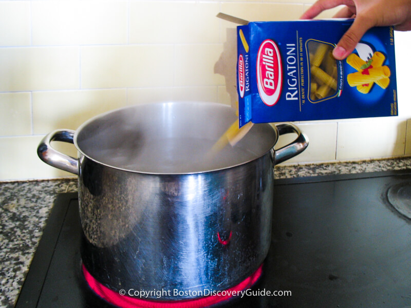Pouring the pasta into the pot