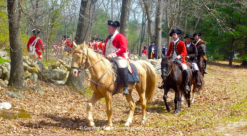 Reenactors portraying British Redcoats as they began their retreat back to Boston from Concord