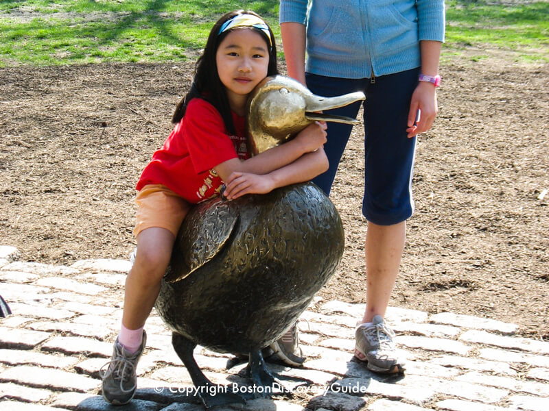 Playing on the Ducklings statue in Boston's Public Garden