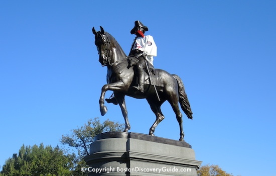 Boston's Public Garden: George Washington is wearing a Red Sox shirt and fake red beard Boston's Public Garden: George Washington is wearing a Red Sox shirt and fake red beard