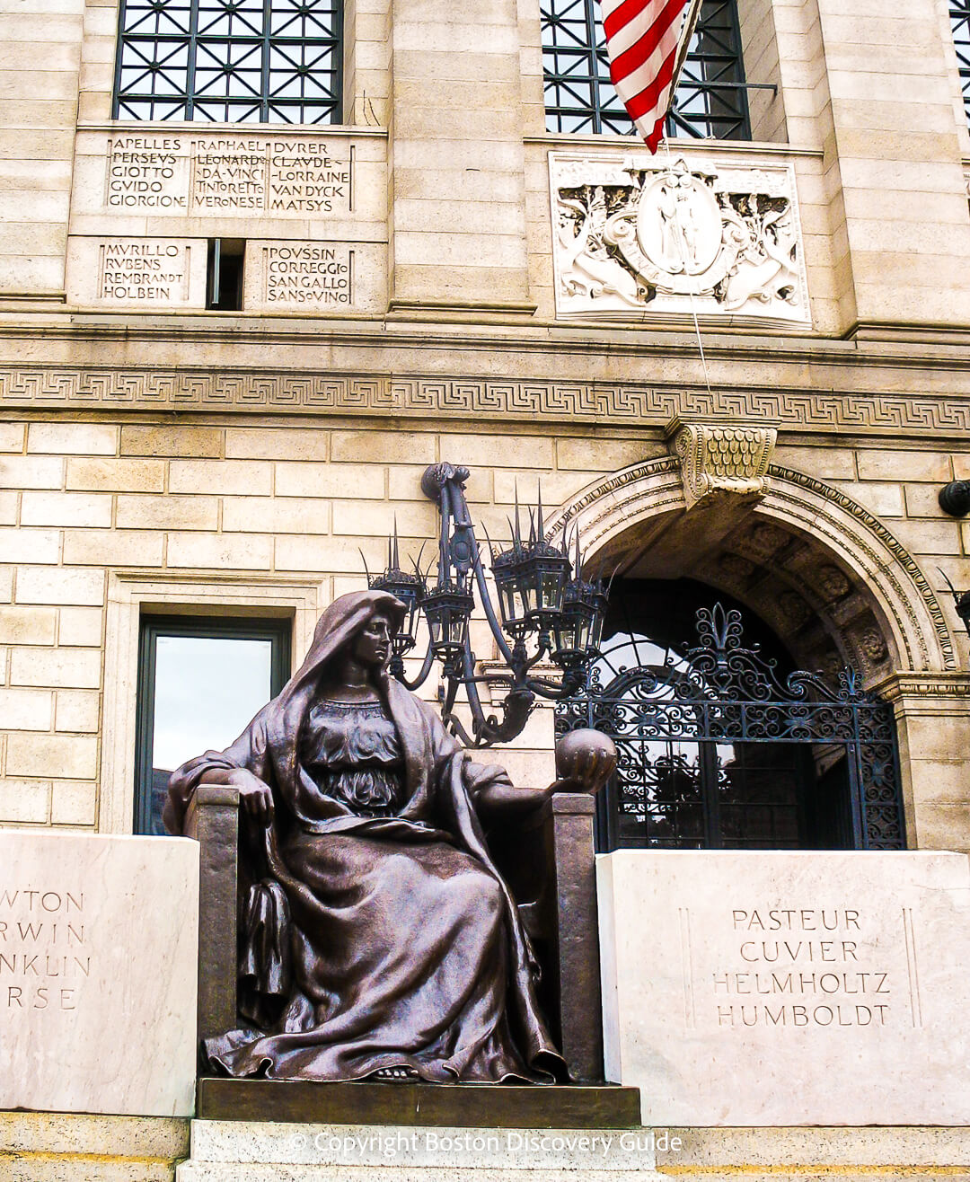 Statue representing Science holding a globe created by Bela Pratt next to names of famous scientists on the McKim Building Statue representing Science holding a globe created by Bela Pratt next to names of famous scientists on the McKim Building