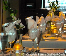Photo of tables set for dinner on Odyssey, Boston cruise