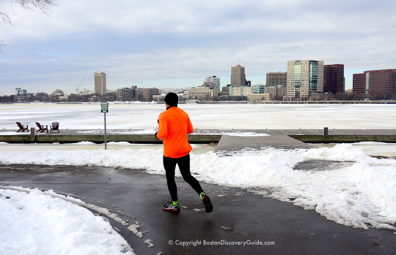 Running along a cleared path on the Esplanade, with the Charles River and Cambridge in the background