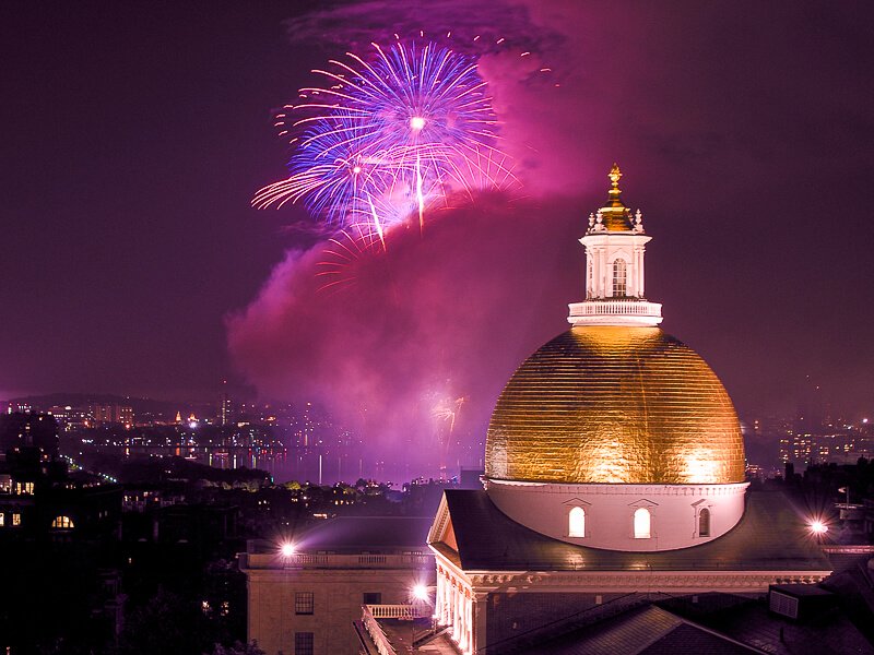 Boston fireworks, seen with the golden dome of the Massachusetts Statehouse in the foreground