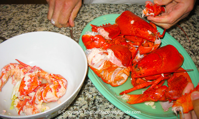 Boiled lobsters being shelled and cut into chunks