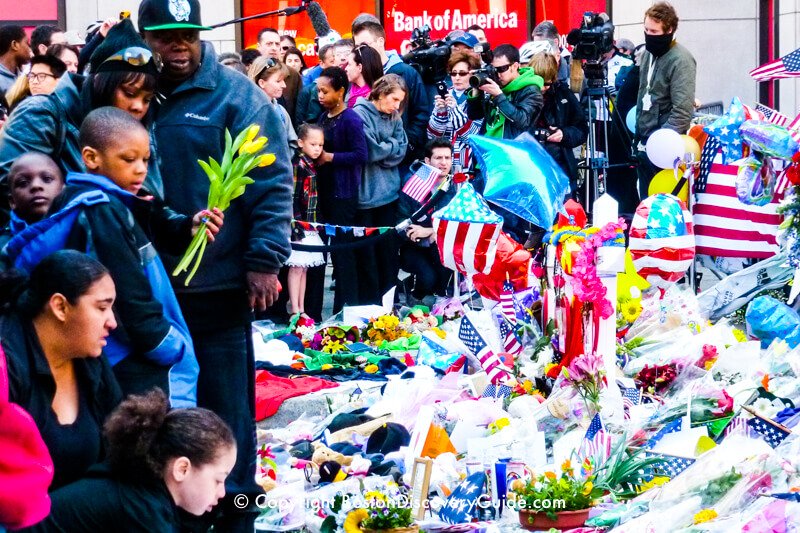 Yellow tulips being added to the memorial at Berkeley and Boylston Streets