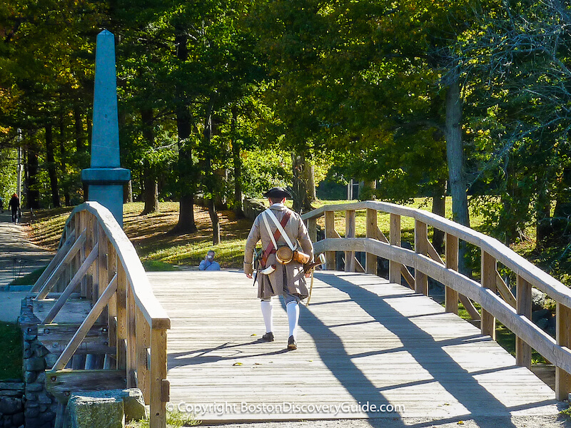 Colonial reenactor crossing Old North Bridge in Concord, MA