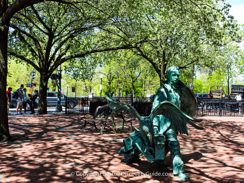 Statue depicting Edgar Allan Poe and a raven at the corner of Boylston and Charles Street South at the edge of the Theatre District across from Boston Common; Poe was born to actor parents in the Theatre District in 1809