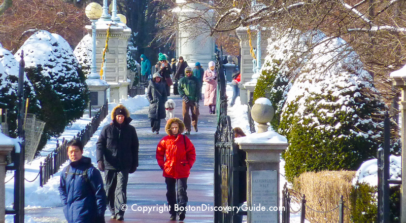 January scene: Walking across the snow-covered footbridge in Boston's Public Garden January scene: Walking across the snow-covered footbridge in Boston's Public Garden