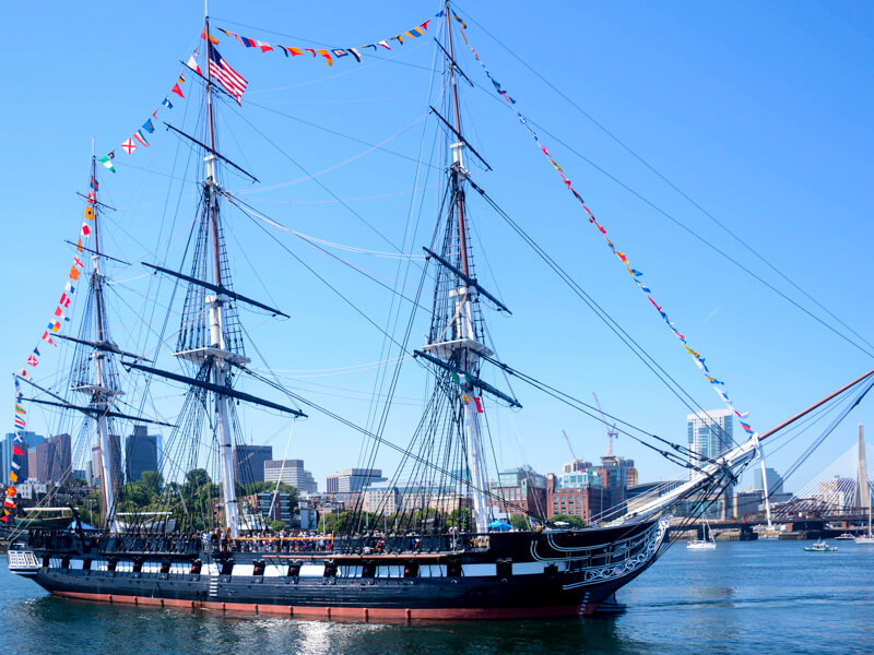 USS Constitution departing for her July 4th turnaround cruise USS Constitution and the Boston skyline
