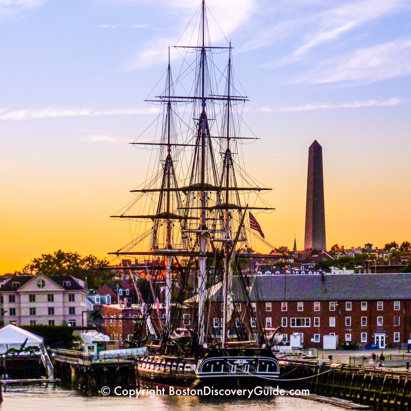 USS Constitution in the Charlestown Navy Yard, with the Bunker Hill Memorial in the background